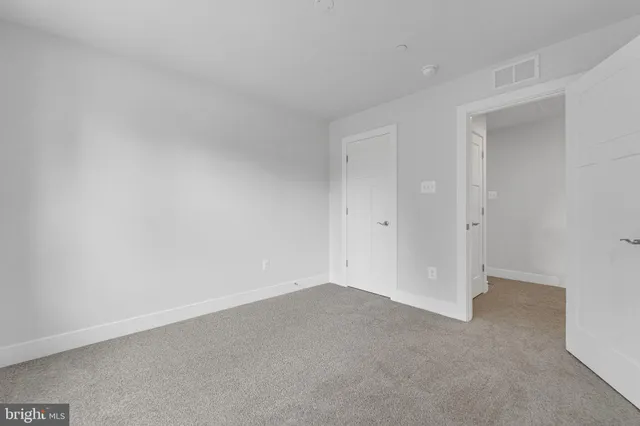 a view of empty room with wooden walls