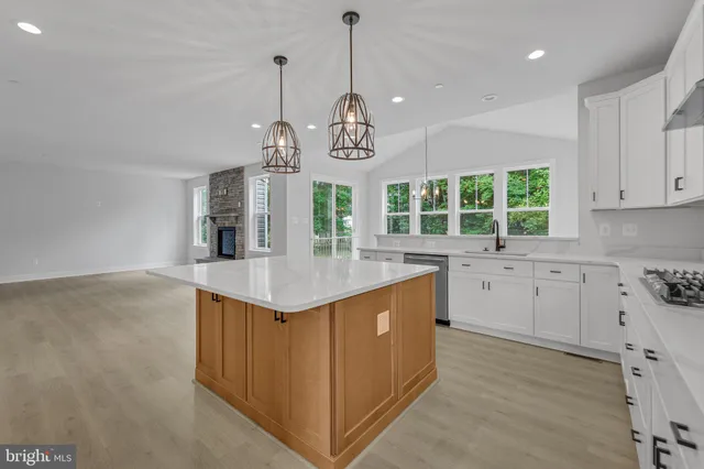 a kitchen with stainless steel appliances white cabinets and a refrigerator