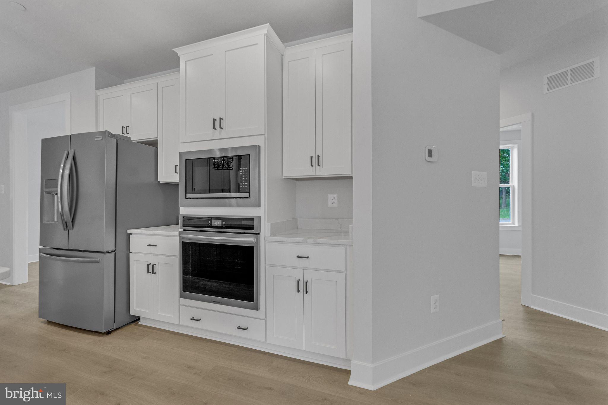1315 Old Fallston Road Fallston, MD 21047 - Photo 9 of 46 a kitchen with stainless steel appliances white cabinets and a refrigerator