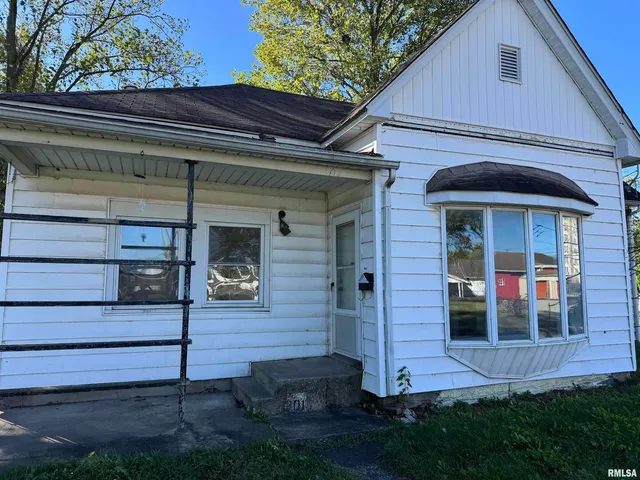 a view of brick house with a small yard