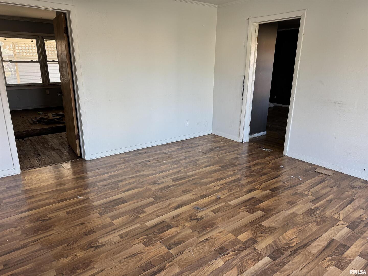 301 East Calvert Street Marion, IL 62959 - Photo 3 of 8 a view of an empty room with wooden floor and a window