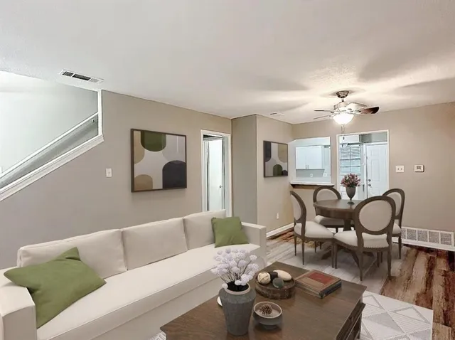 a living room with furniture and wooden floor