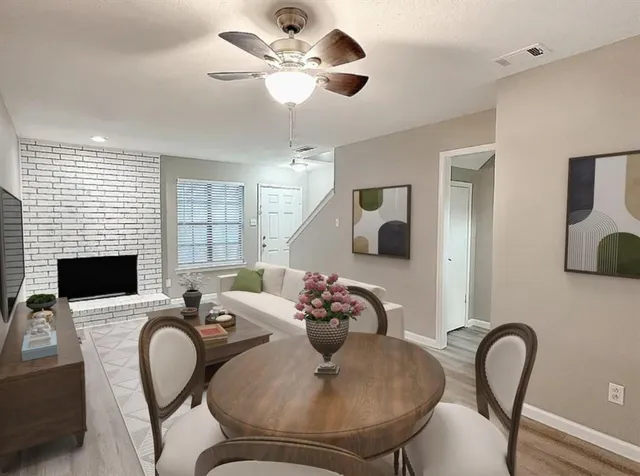 a living room with furniture chandelier and a fireplace