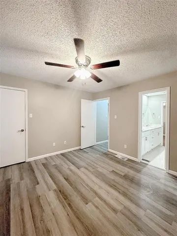 a view of an empty room and wooden floor