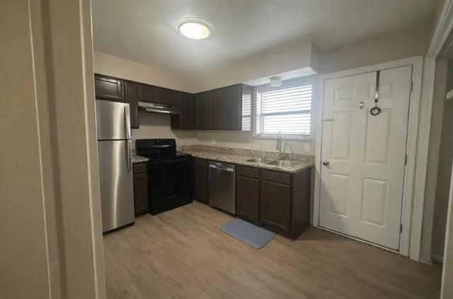 a kitchen with a refrigerator and a sink
