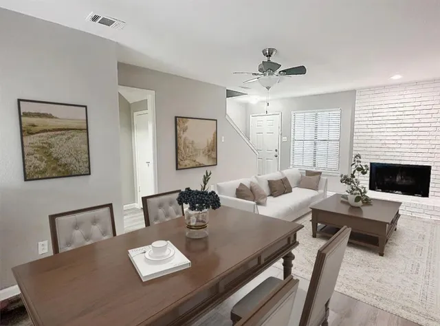 a living room with furniture fireplace and a table