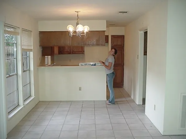 a view of a kitchen with a sink and chandelier