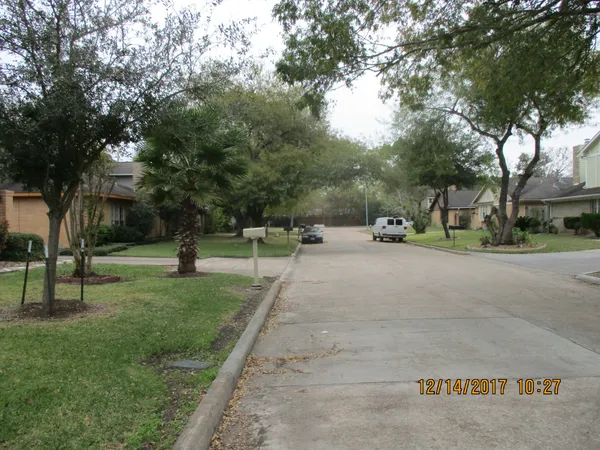 a view of street with parked cars