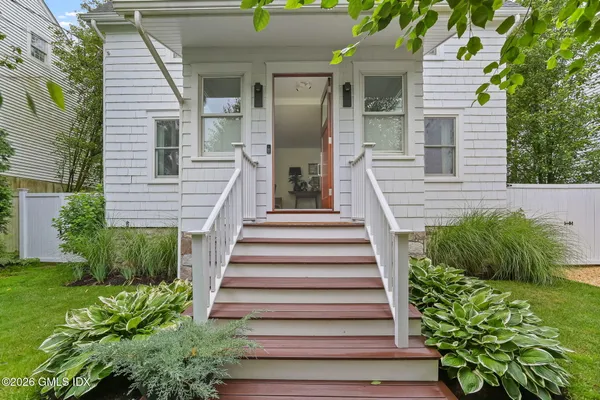 a view of a house with potted plants