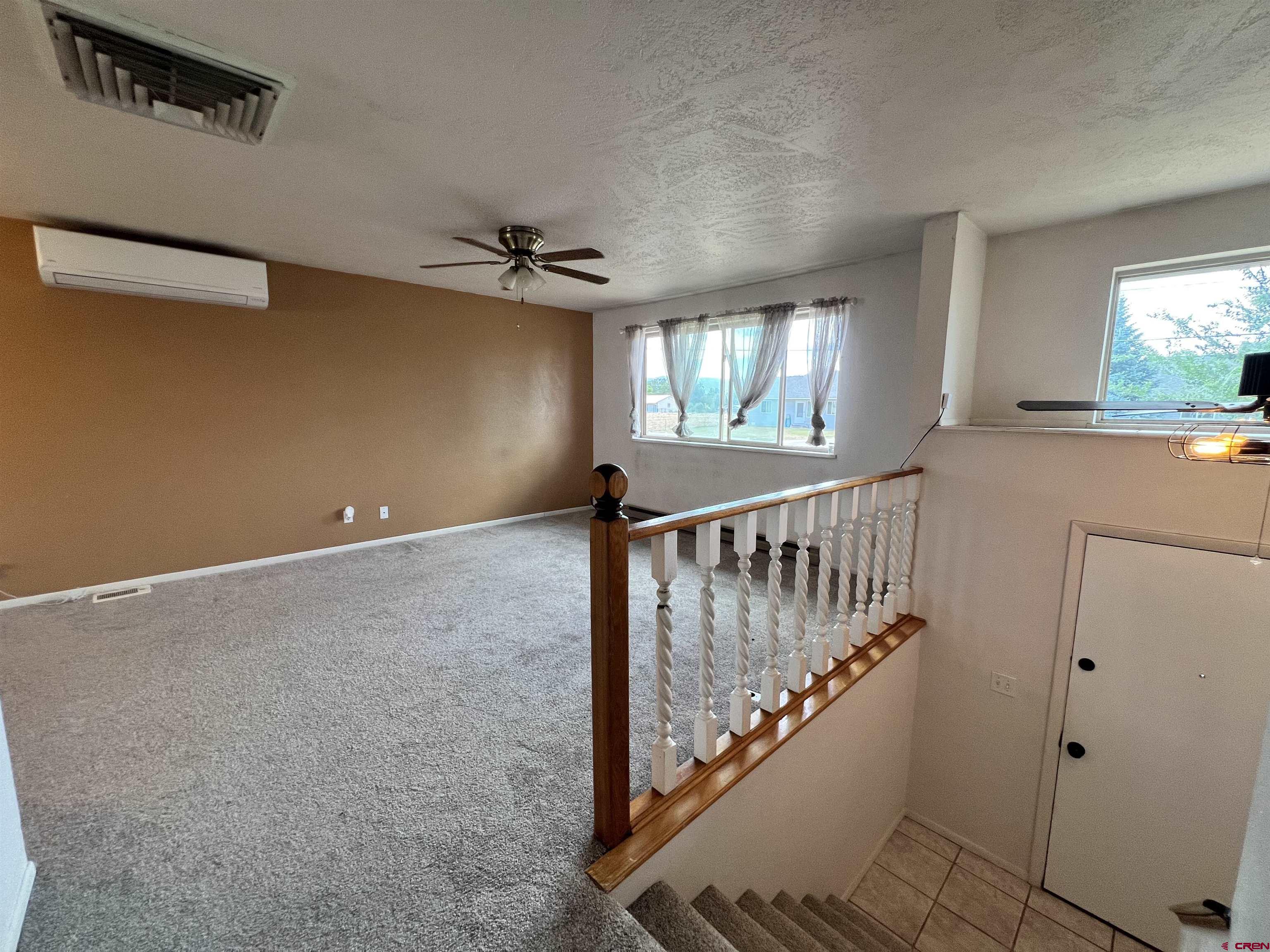 1328 Jackson Street Cortez, CO 81321 - Photo 6 of 37 a view of entryway with stairs and wooden floor