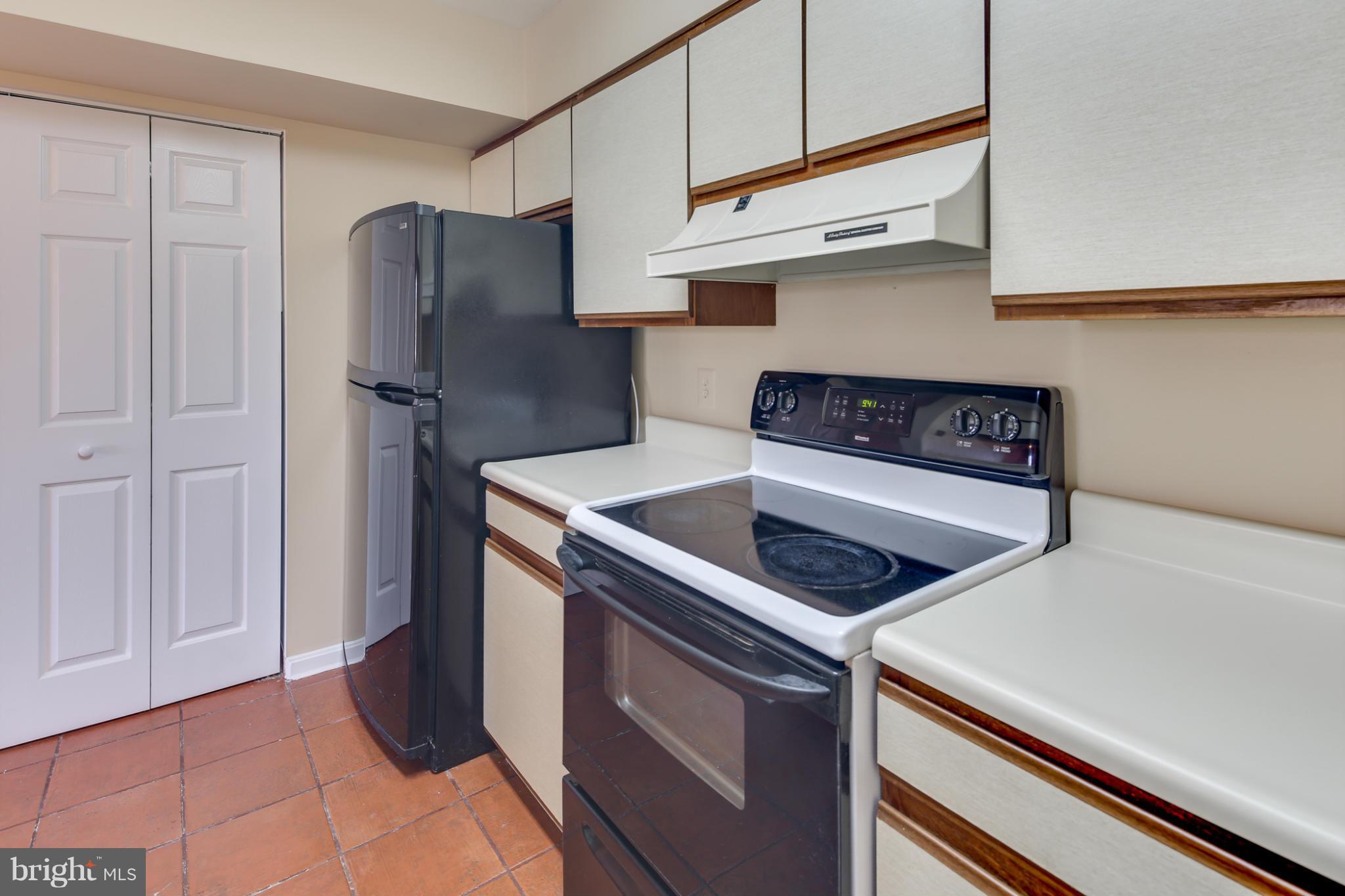 4912 Columbia Road, Unit 6111 Columbia, MD 21044 - Photo 11 of 29 a kitchen with stainless steel appliances granite countertop a refrigerator and a stove
