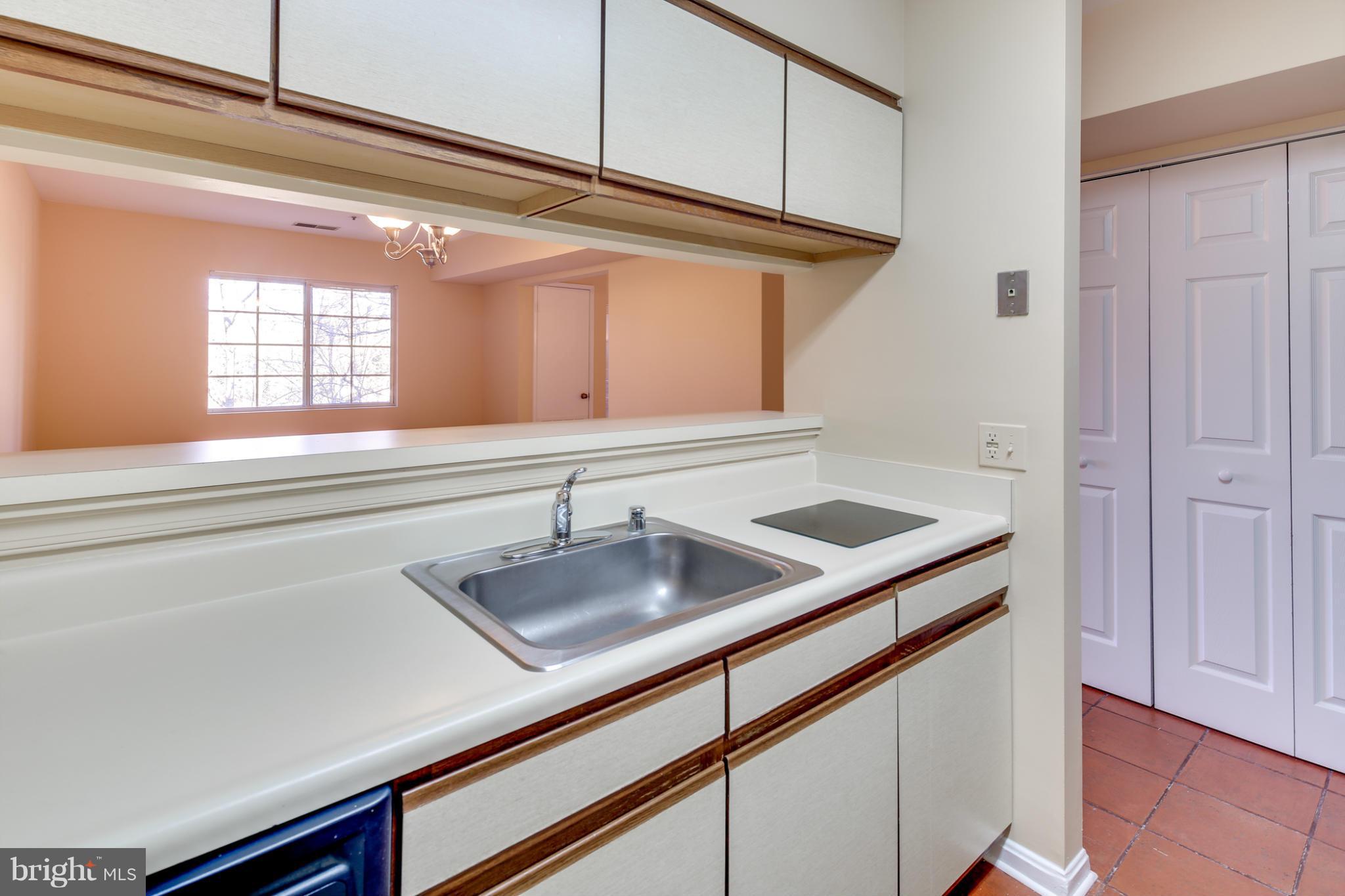 4912 Columbia Road, Unit 6111 Columbia, MD 21044 - Photo 12 of 29 a kitchen with a sink and a window