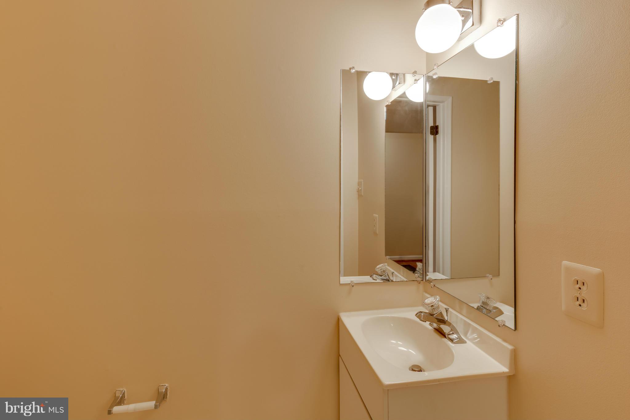 4912 Columbia Road, Unit 6111 Columbia, MD 21044 - Photo 15 of 29 a bathroom with a sink and a mirror
