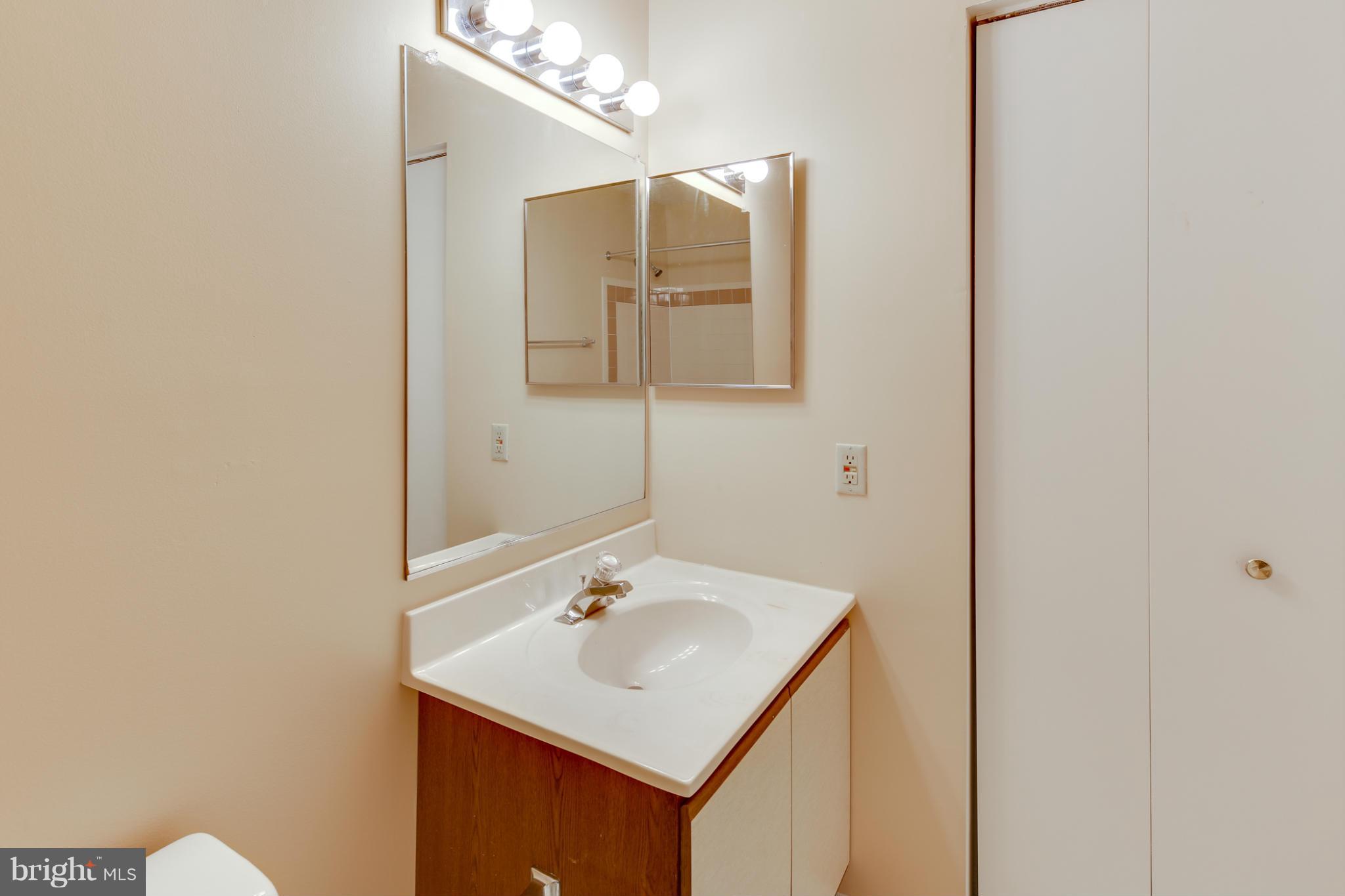 4912 Columbia Road, Unit 6111 Columbia, MD 21044 - Photo 24 of 29 a bathroom with a sink and a mirror