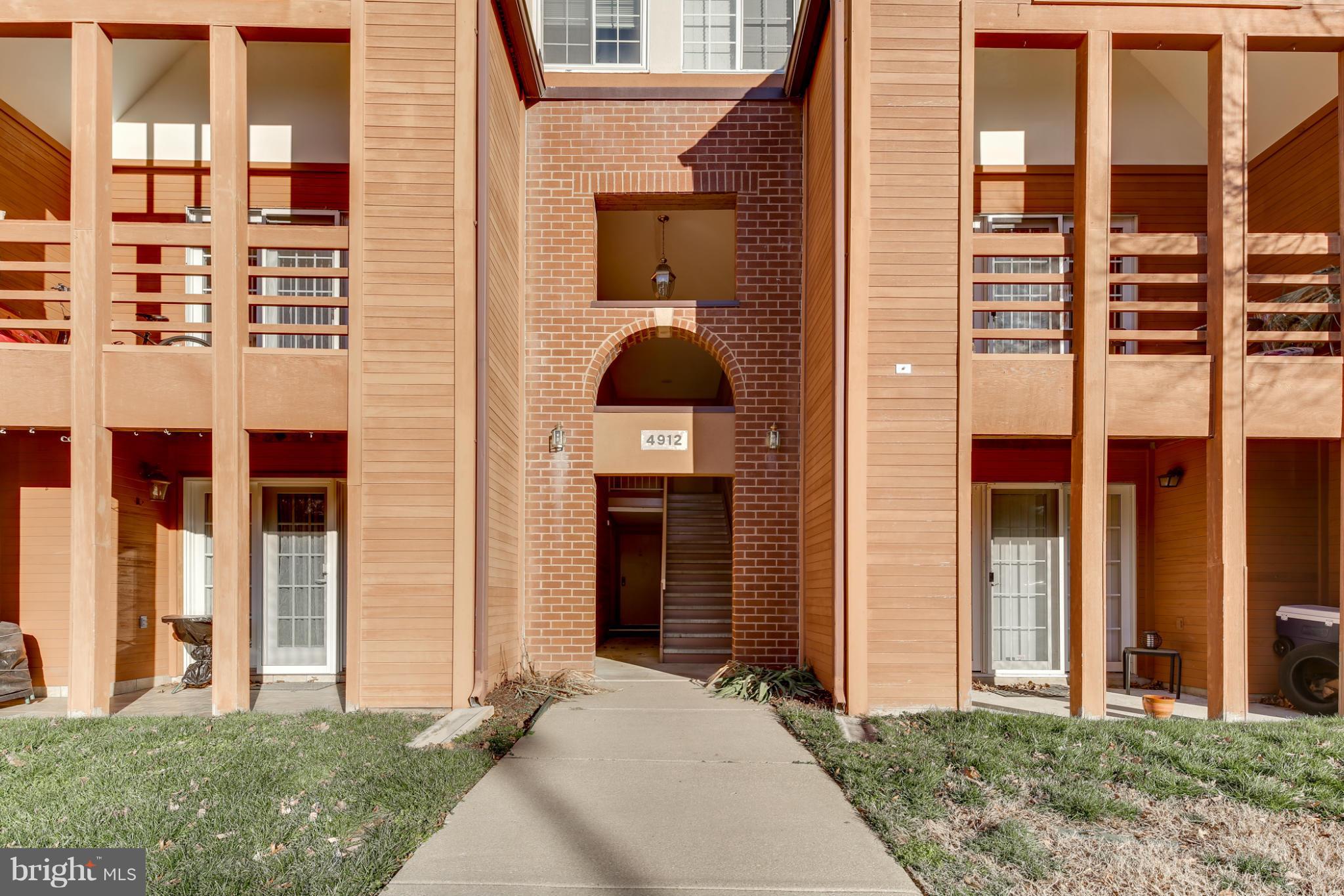 4912 Columbia Road, Unit 6111 Columbia, MD 21044 - Photo 29 of 29 a front view of a house with a yard
