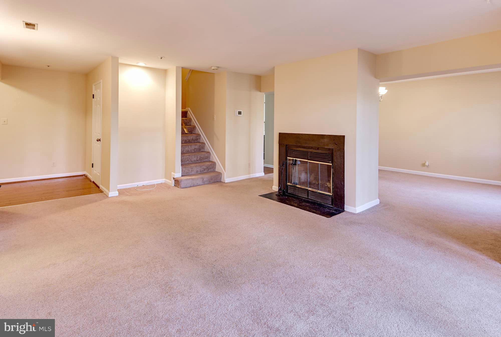 4912 Columbia Road, Unit 6111 Columbia, MD 21044 - Photo 4 of 29 an empty room with fireplace and windows