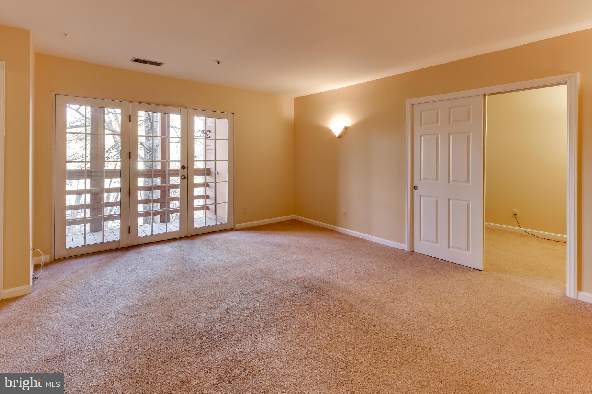 4912 Columbia Road, Unit 6111 Columbia, MD 21044 - Photo 5 of 29 an empty room with windows and closet
