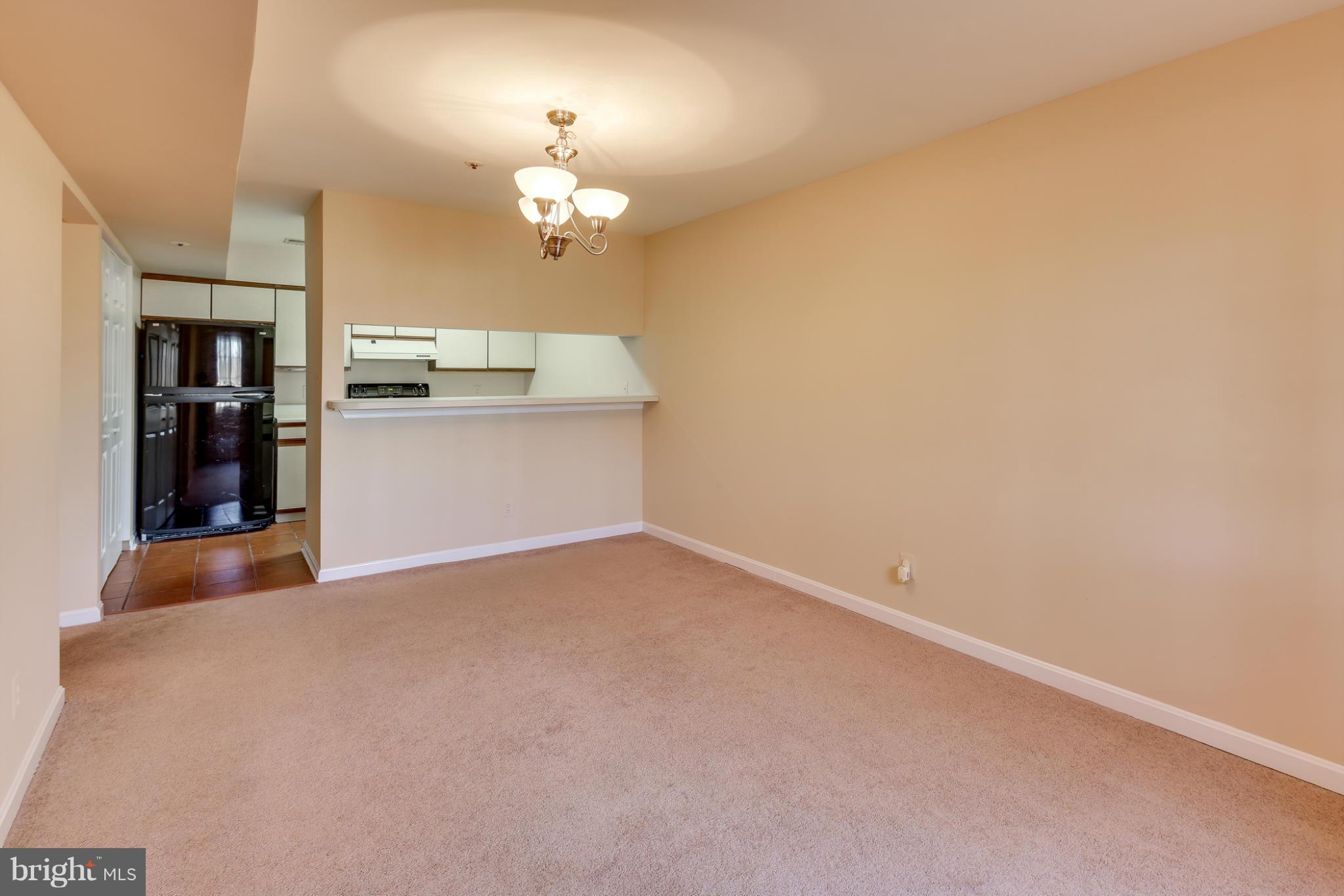 4912 Columbia Road, Unit 6111 Columbia, MD 21044 - Photo 7 of 29 a view of a room with a chandelier