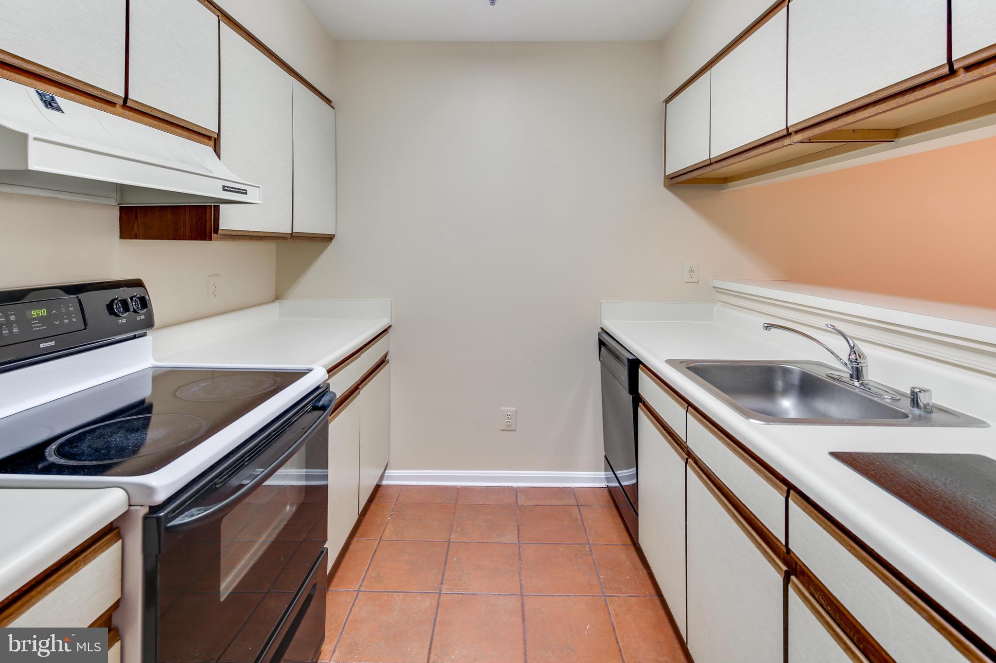 4912 Columbia Road, Unit 6111 Columbia, MD 21044 - Photo 9 of 29 a kitchen with stainless steel appliances granite countertop a sink and cabinets