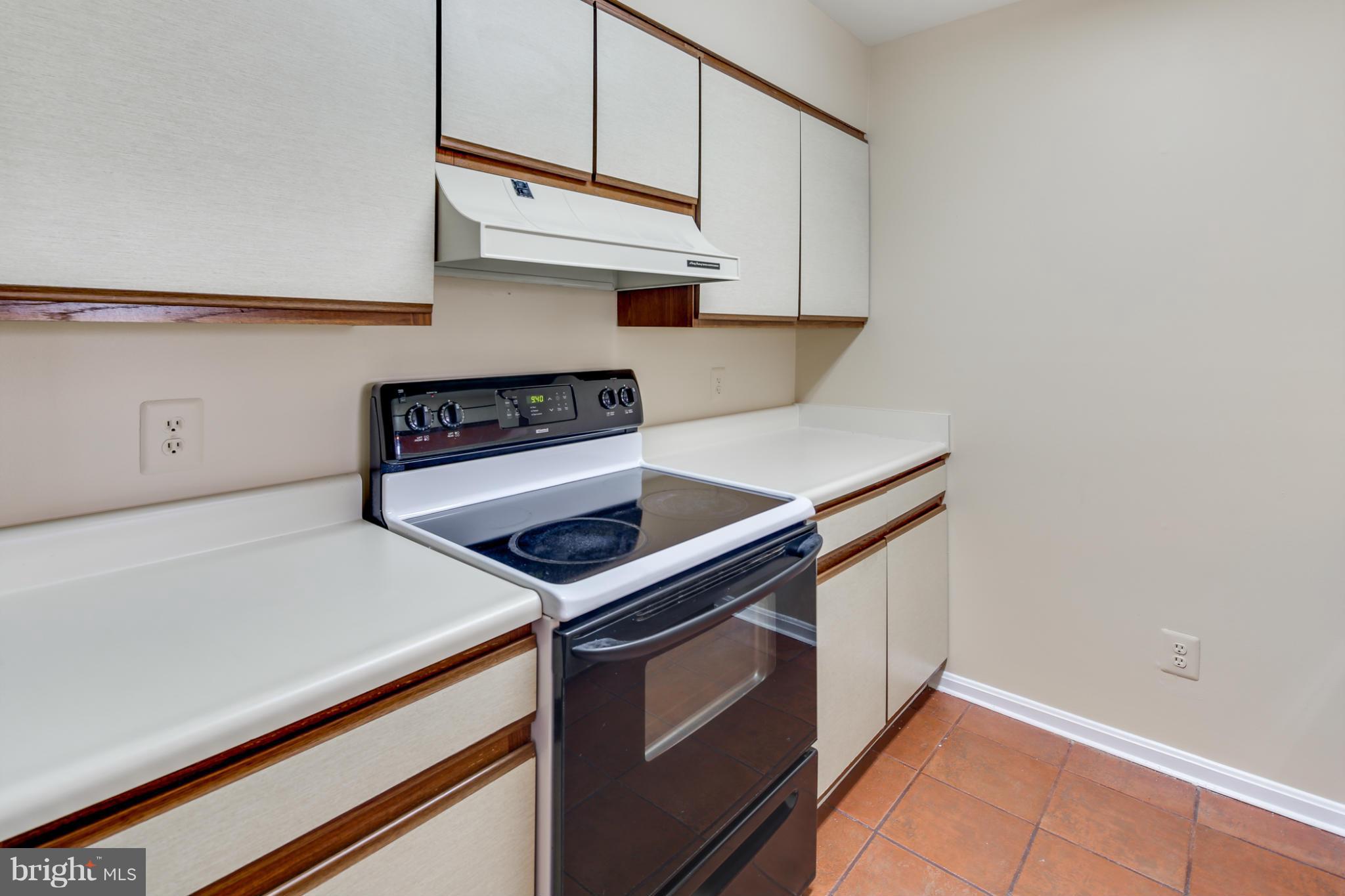 4912 Columbia Road, Unit 6111 Columbia, MD 21044 - Photo 10 of 29 a kitchen with stainless steel appliances a stove and a refrigerator