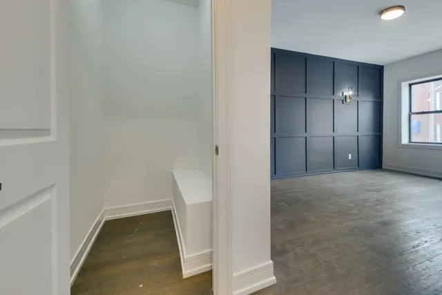 an empty room with windows and closet