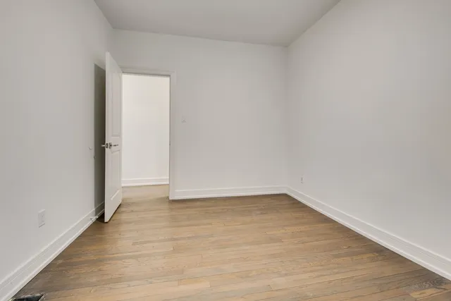 a view of an empty room and wooden floor