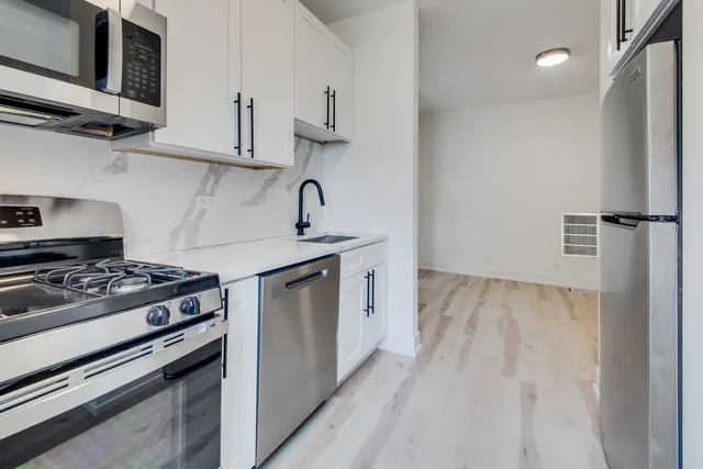 a kitchen with stainless steel appliances a refrigerator stove and sink