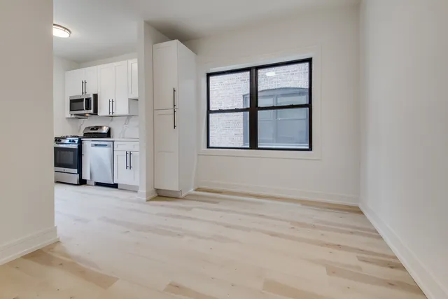 a view of a kitchen with a stove cabinets and a window
