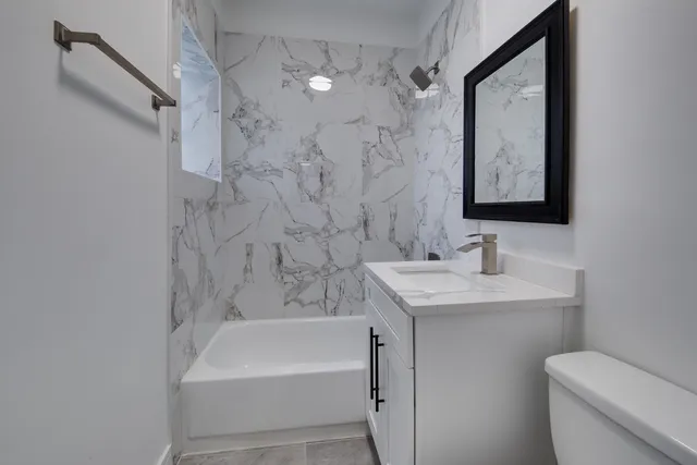 a bathroom with a sink a toilet and a bathtub