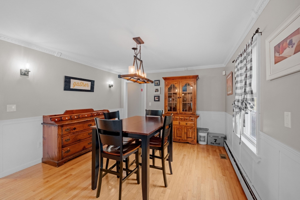 275 Lucas Road Manchester, NH 03109 - Photo 15 of 39 a view of a dining room with furniture window and wooden floor