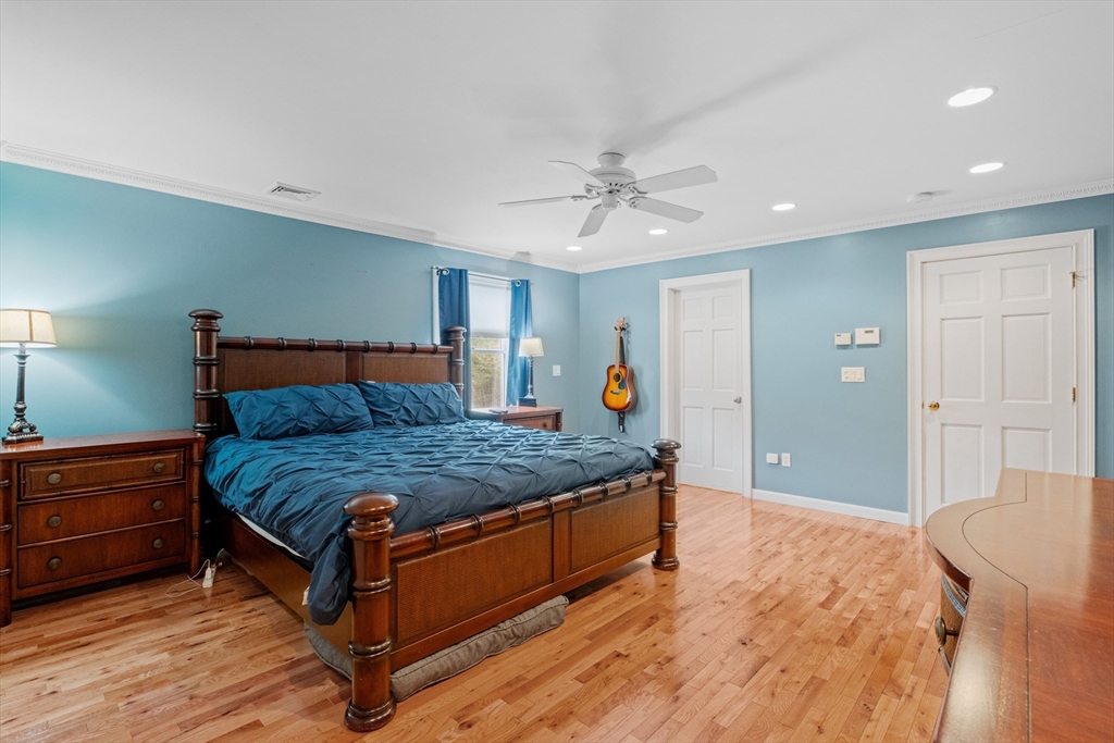 275 Lucas Road Manchester, NH 03109 - Photo 18 of 39 a spacious bedroom with a bed and a chandelier