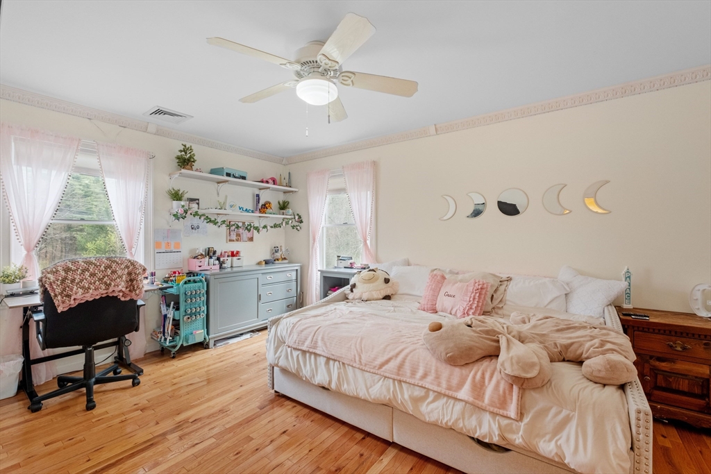 275 Lucas Road Manchester, NH 03109 - Photo 24 of 39 a bedroom with a bed wooden floor and a table