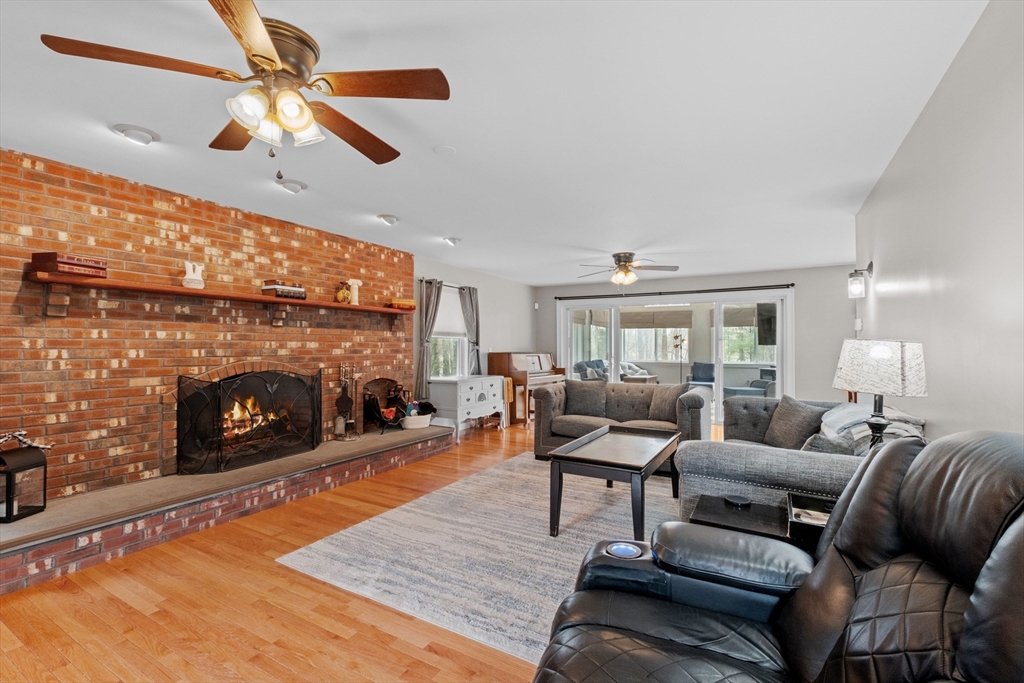 275 Lucas Road Manchester, NH 03109 - Photo 3 of 39 a living room with furniture a fireplace and a ceiling fan