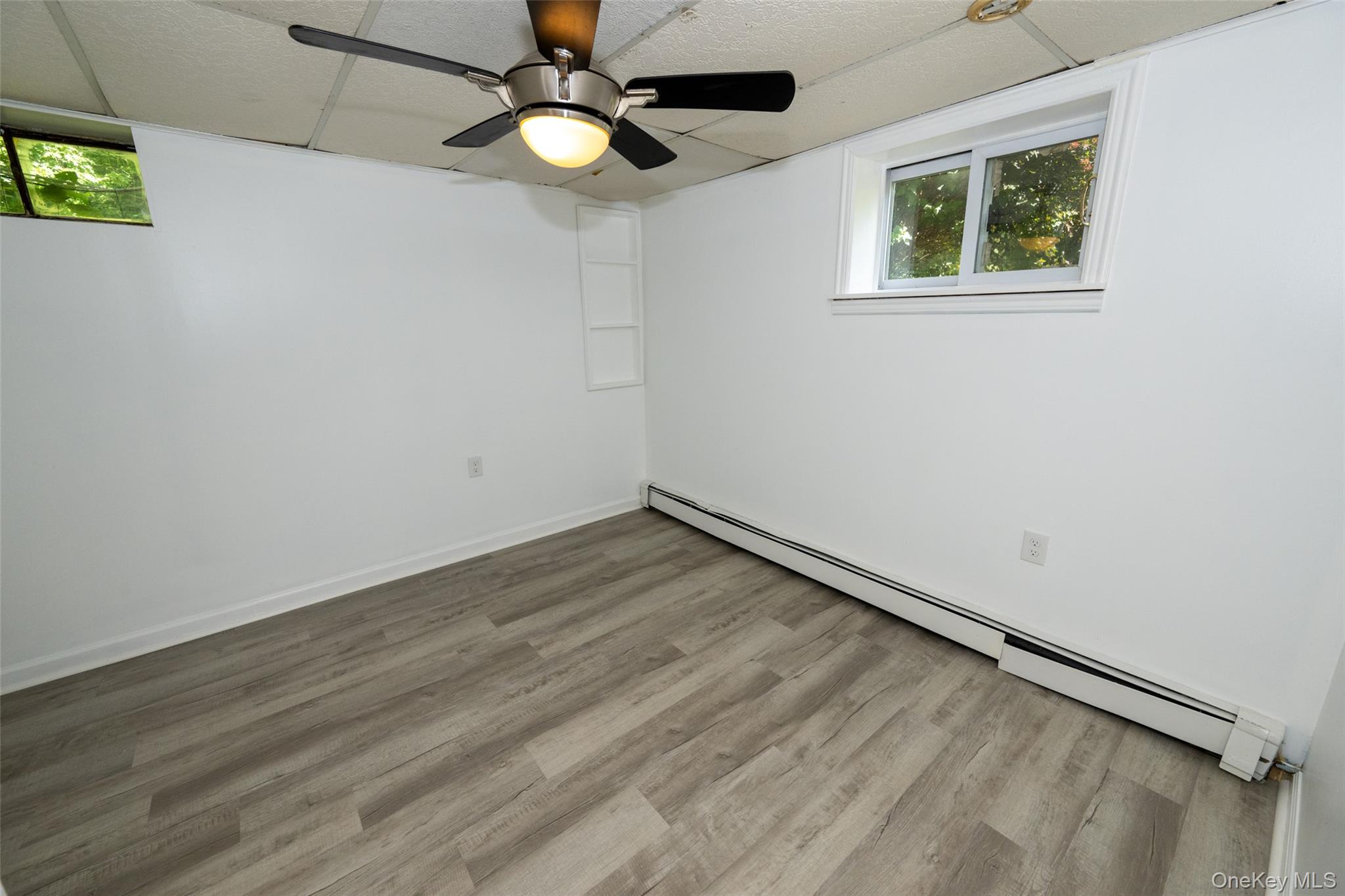 136 Foggintown Road Brewster, NY 10509 - Photo 37 of 50 an empty room with a window and a ceiling fan