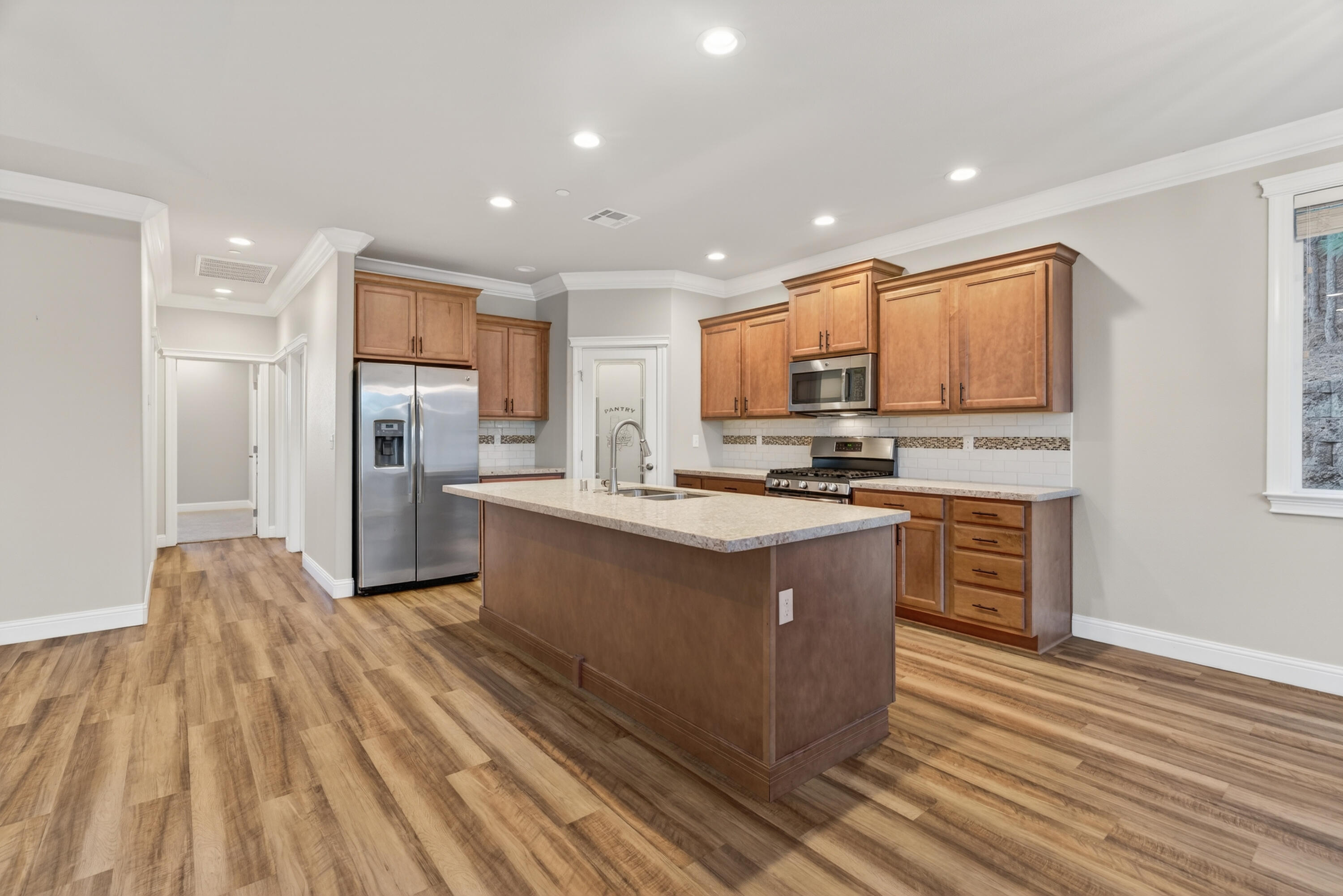 4585 Risstay Way Shasta Lake, CA 96019 - Photo 11 of 36 a kitchen with stainless steel appliances granite countertop a stove a refrigerator and a microwave oven with wooden floor