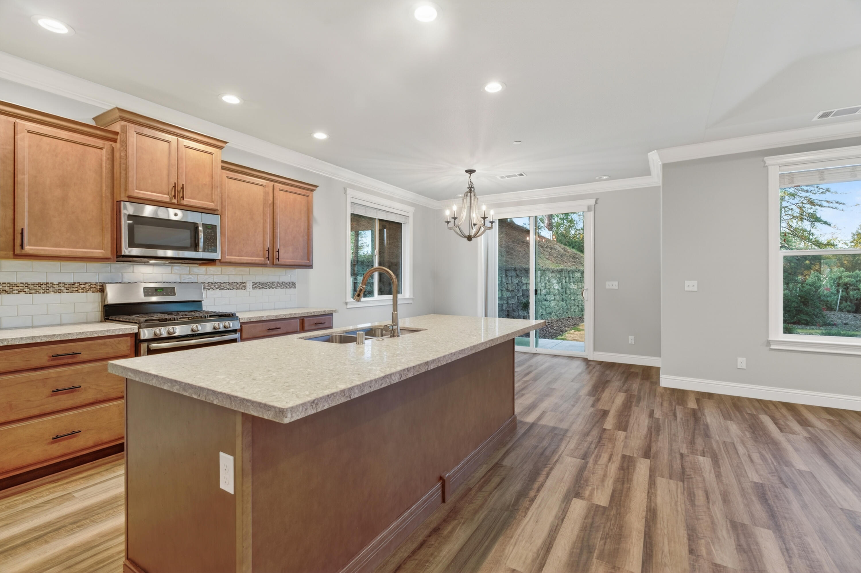 4585 Risstay Way Shasta Lake, CA 96019 - Photo 12 of 36 a large kitchen with stainless steel appliances granite countertop a large stove a sink dishwasher and a microwave oven with cabinets