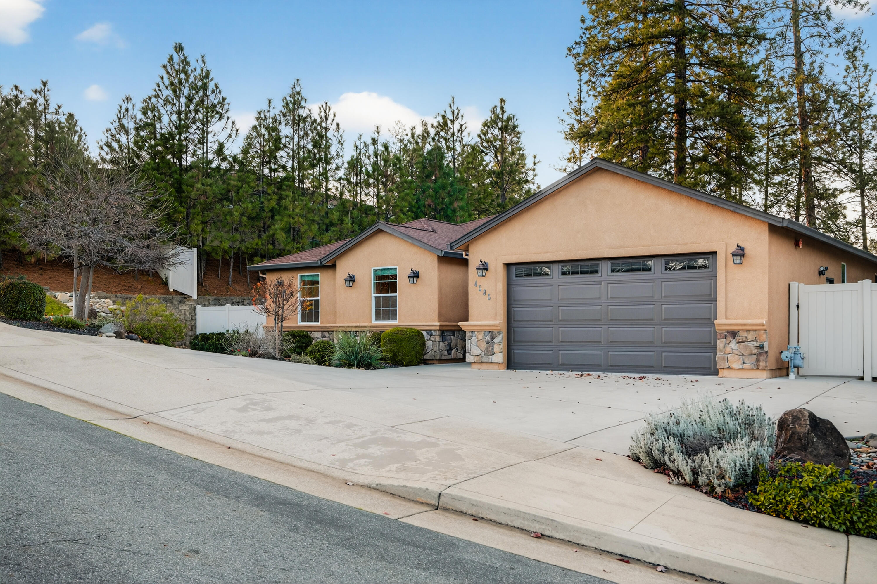 4585 Risstay Way Shasta Lake, CA 96019 - Photo 2 of 36 a front view of a house with a yard and garage
