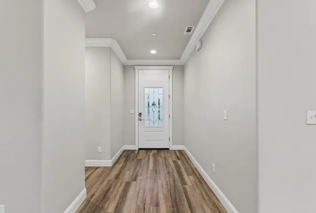 a view of a hallway with wooden floor