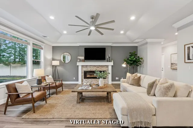a living room with furniture a fireplace and a flat screen tv