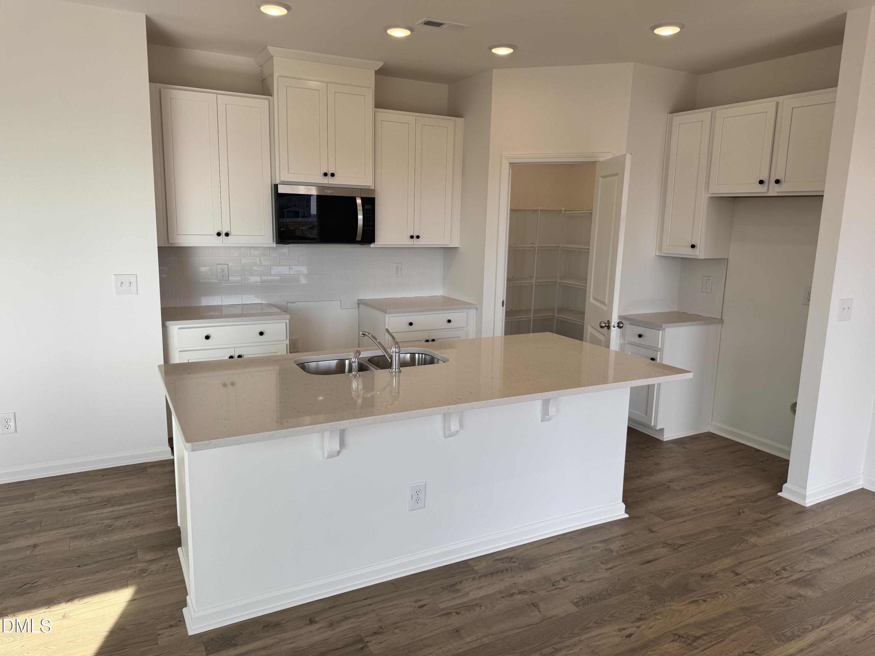 151 Sprenger Street Garner, NC 27529 - Photo 2 of 22 a kitchen with stainless steel appliances a sink a stove a microwave and cabinets