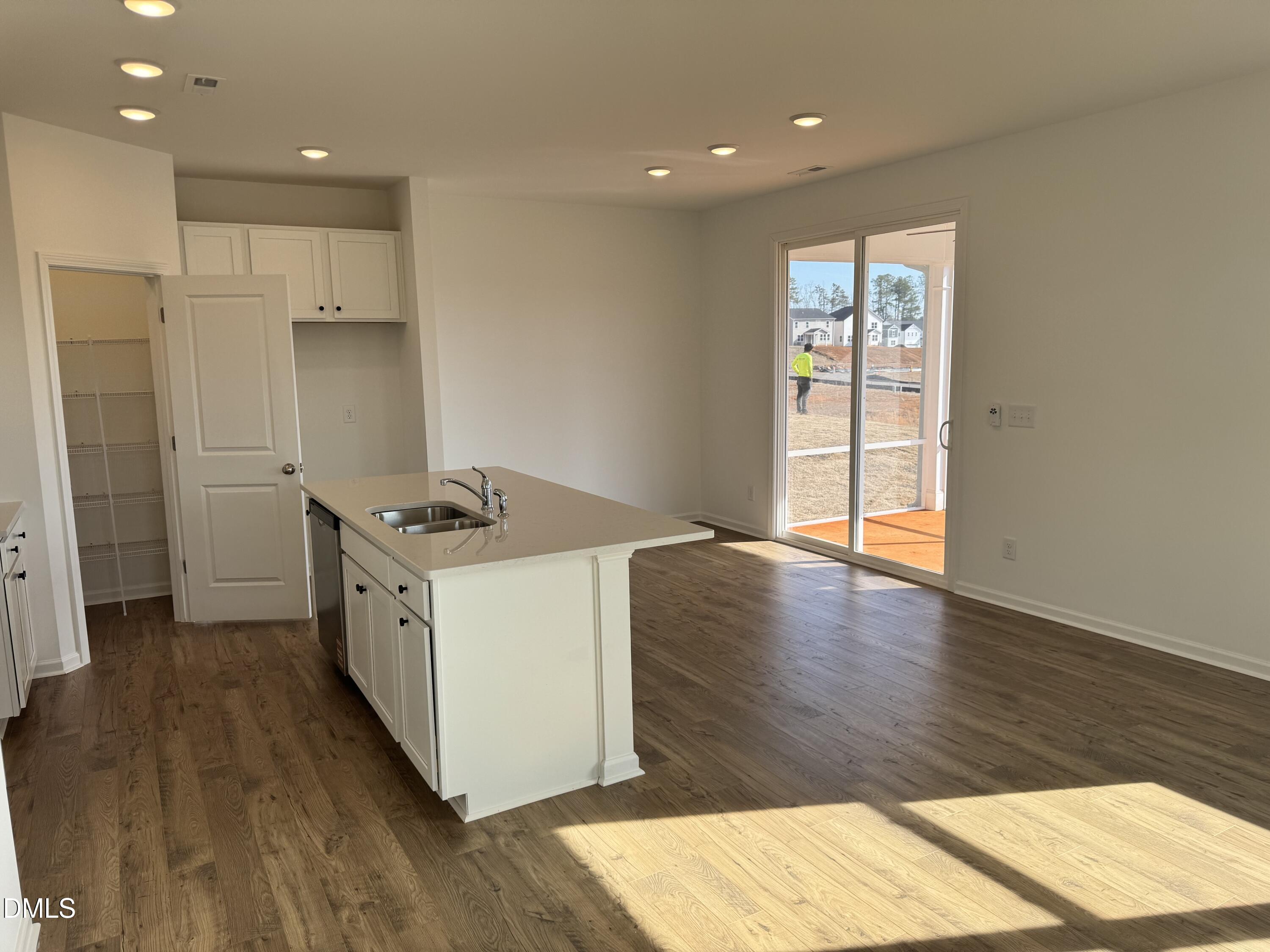 151 Sprenger Street Garner, NC 27529 - Photo 7 of 22 a open kitchen with stainless steel appliances granite countertop a stove a sink and a refrigerator with wooden floor