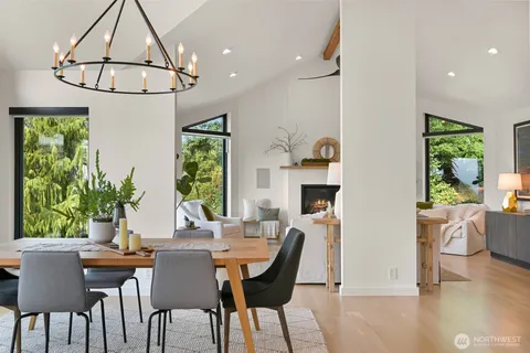 a dining room with furniture a window and a chandelier