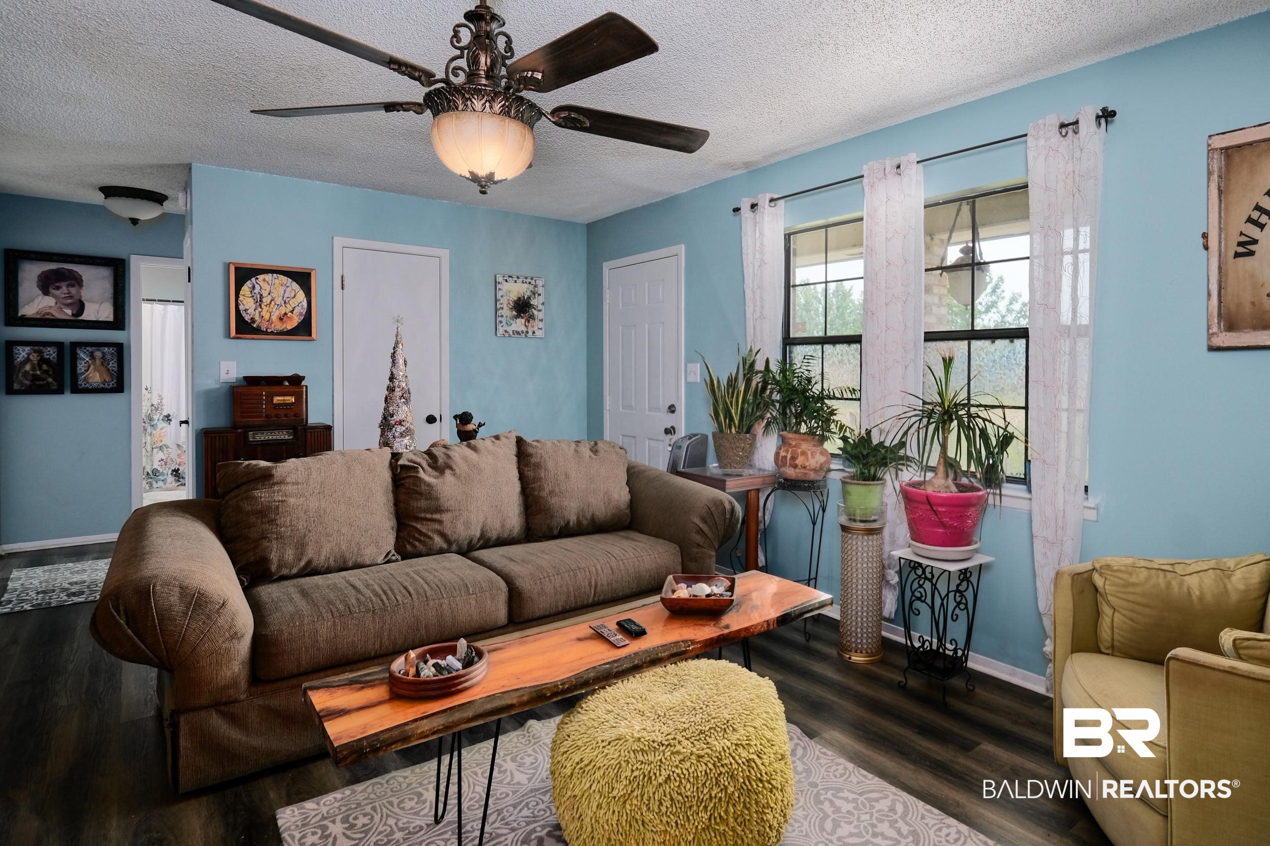 504 Ariel Avenue Foley, AL 36535 - Photo 13 of 33 Living room with a textured ceiling, dark hardwood / wood-style flooring, and ceiling fan