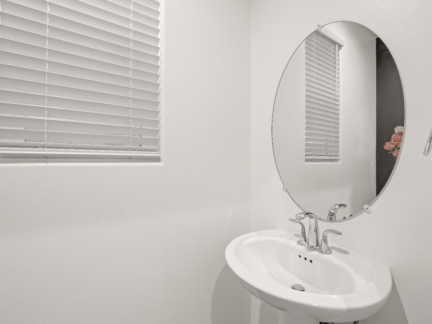 867 Fir Street Madera, CA 93636 - Photo 15 of 39 a bathroom with a sink and a mirror