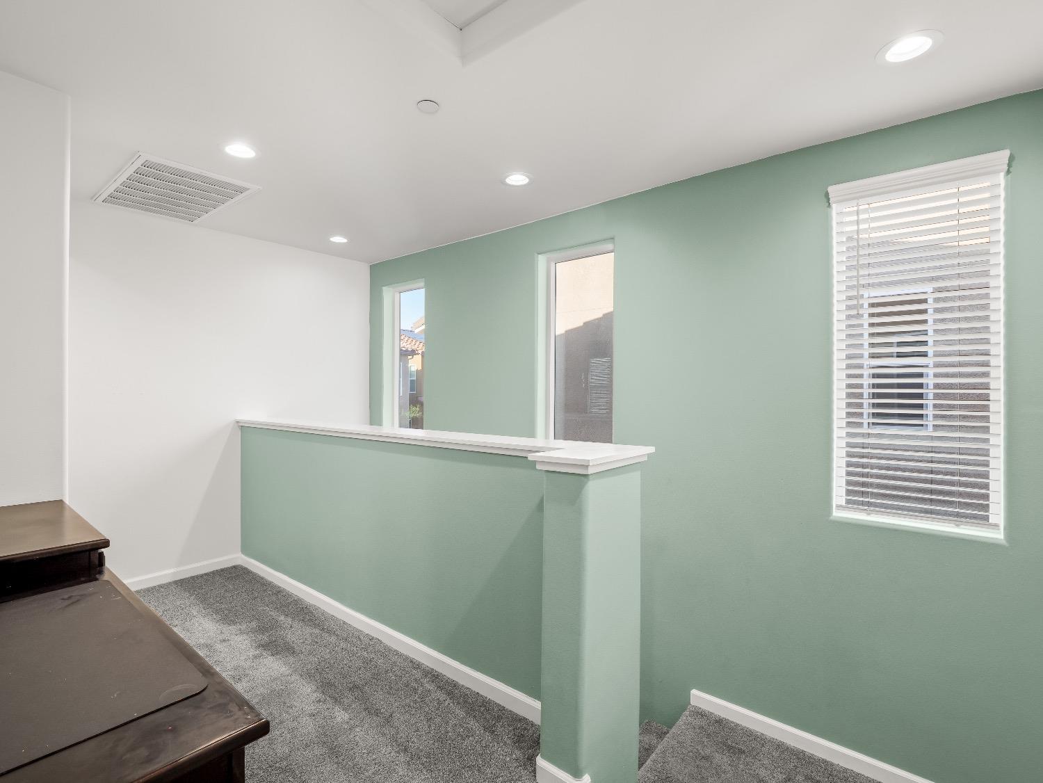 867 Fir Street Madera, CA 93636 - Photo 16 of 39 a view of hallway with window and wooden floor