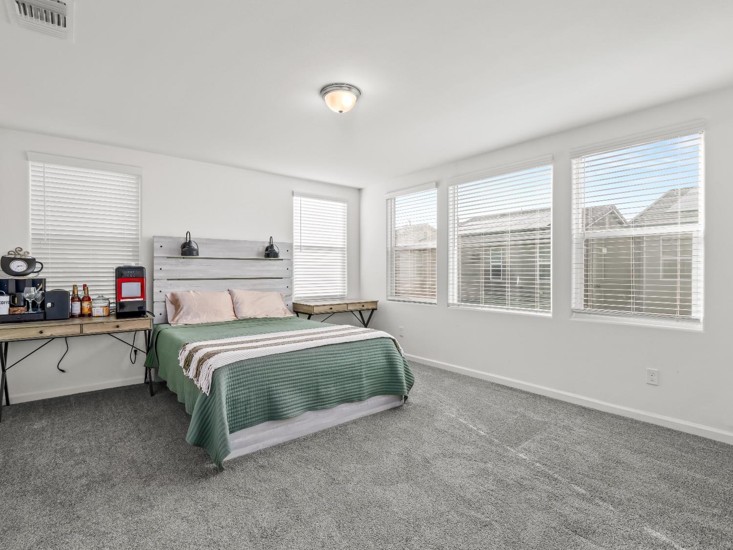 867 Fir Street Madera, CA 93636 - Photo 17 of 39 a spacious bedroom with a bed and wooden floor