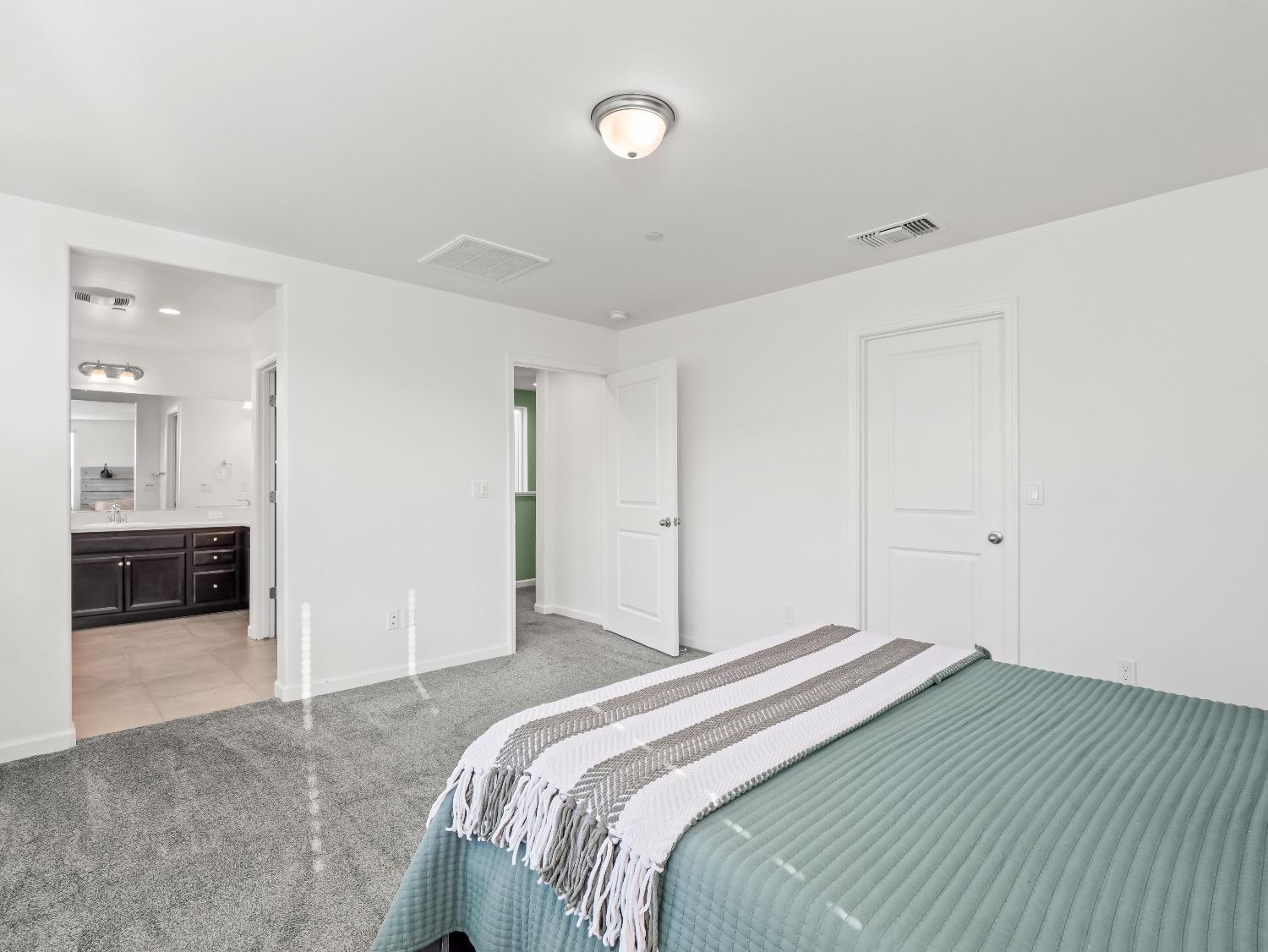 867 Fir Street Madera, CA 93636 - Photo 18 of 39 a bedroom with a bed and a view of kitchen