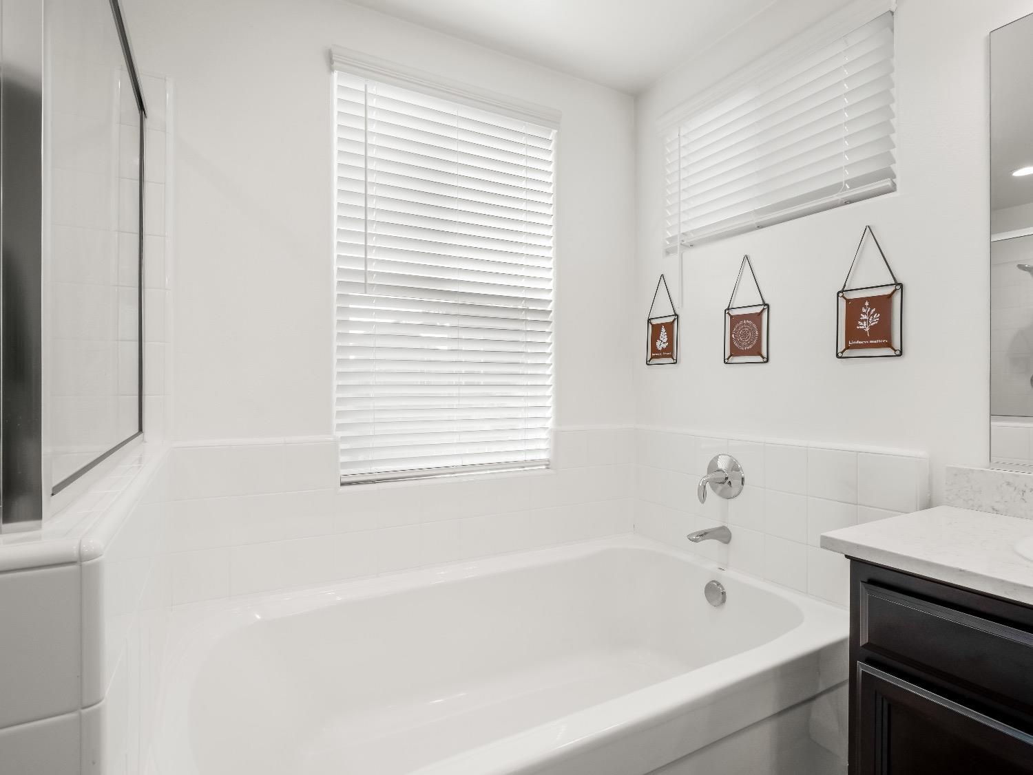 867 Fir Street Madera, CA 93636 - Photo 20 of 39 a white bath tub sitting next to a white sink