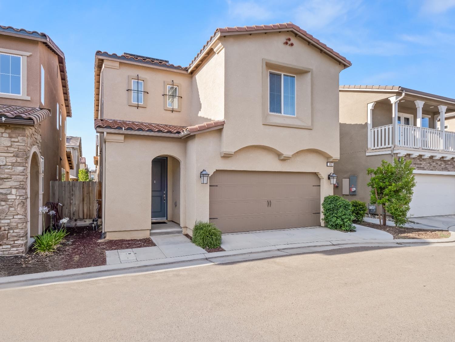 867 Fir Street Madera, CA 93636 - Photo 2 of 39 a front view of a house with garden