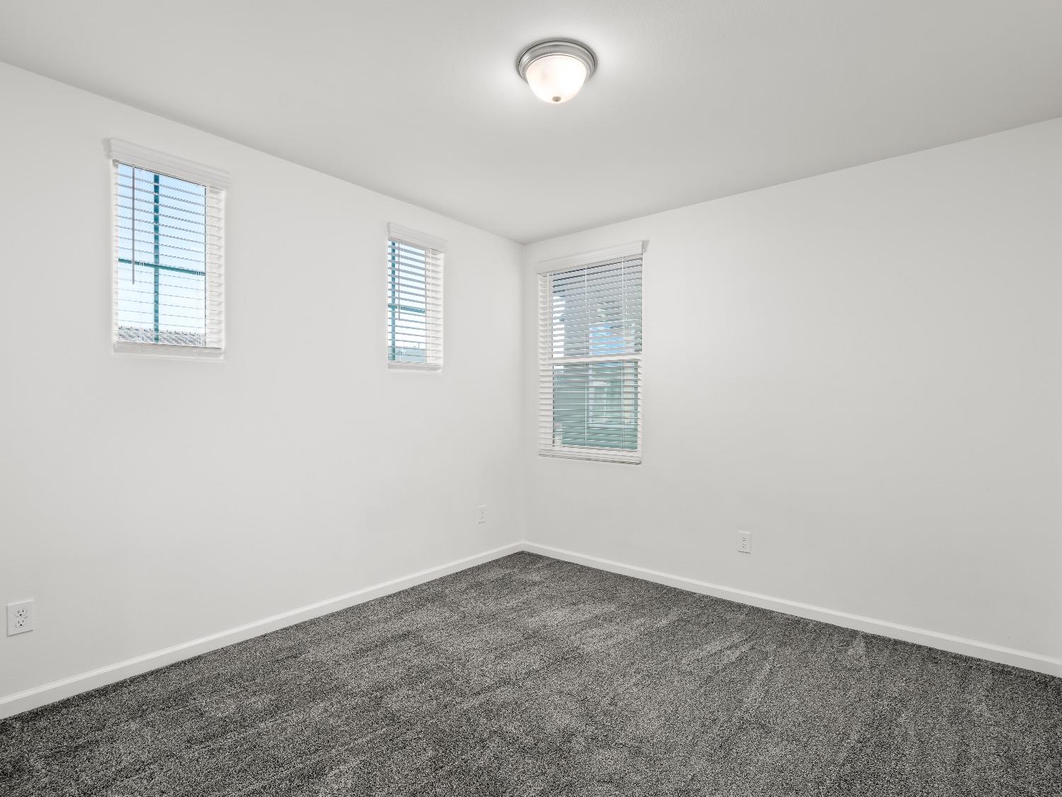 867 Fir Street Madera, CA 93636 - Photo 25 of 39 an empty room with windows